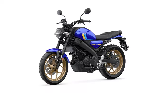 Blue Yamaha motorcycle with black frame and gold alloy wheels, angled toward the left.