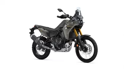 Yamaha Tenere 700 adventure motorcycle shown from a front-right angle with olive-gray body and gold front forks.",