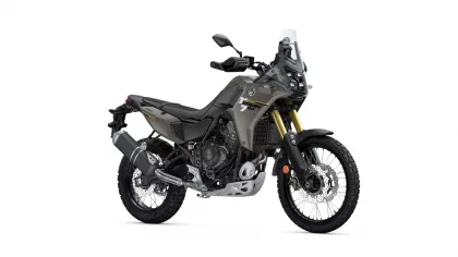 Side view of a Yamaha Tenere 700 adventure motorcycle with olive-gray body, gold front forks, and large front windscreen