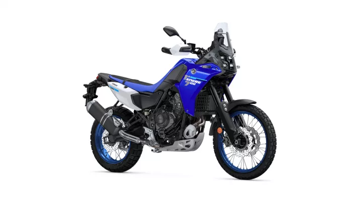 Blue Yamaha Tenere 700 adventure motorcycle shown from the left side with knobby tires and windscreen.
