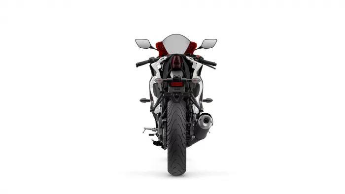 Rear view of a sport motorcycle with a single exhaust on the right and red accent seat against a white background, showing taillight and license plate area