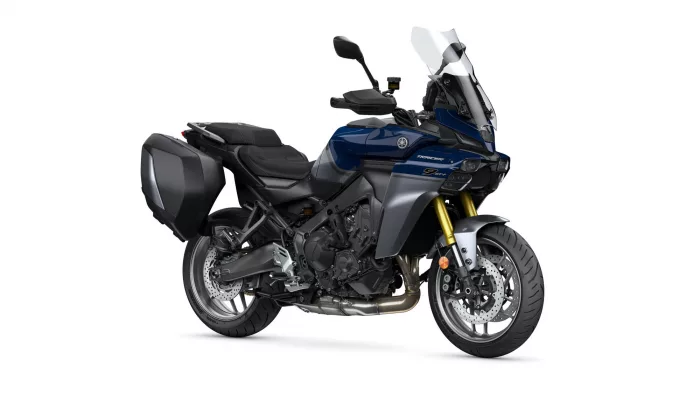 Blue Yamaha Tracer touring motorcycle with hard side panniers and tall windshield, shown in a three-quarter front view