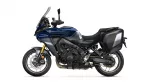 Blue Yamaha Tracer 9 GT adventure motorcycle shown from the left side with dark side panniers and a tall windshield for touring.