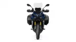 Front view of a blue adventure motorcycle with a tall windshield, side panniers, and gold front forks