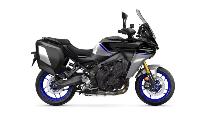 Side view of a black Yamaha Tracer 9 GT sport-touring motorcycle with blue accents and panniers.