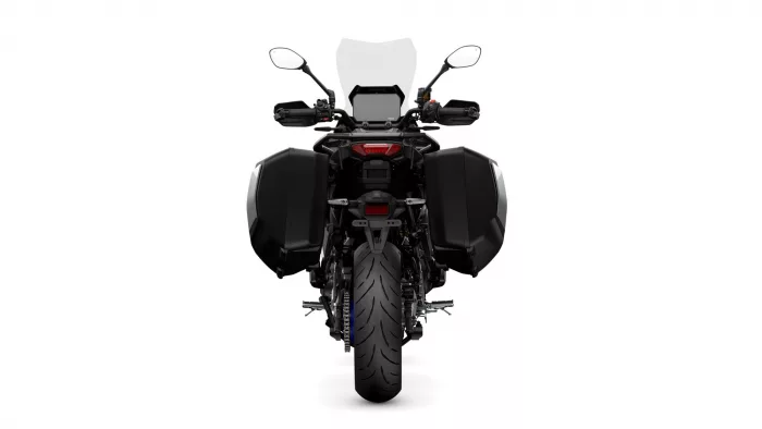 Rear view of a black adventure motorcycle with side panniers and a tall windshield, isolated on white background typically used for product photos.