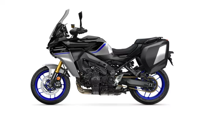 Black Yamaha Tracer motorcycle shown in profile with blue accents and silver side panniers, isolated on white background.