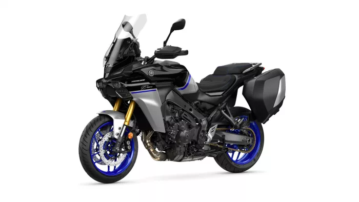 Yamaha Tracer 9 GT sport-touring motorcycle with a windscreen, black body, and blue-rimmed wheels plus side panniers