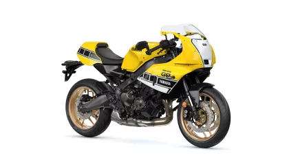 Yellow Yamaha sport motorcycle with black frame and gold wheels, viewed from the side on a white background
