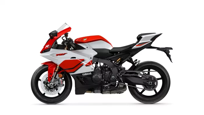 Side view of a red, white, and black Yamaha R1 sport motorcycle on a white background