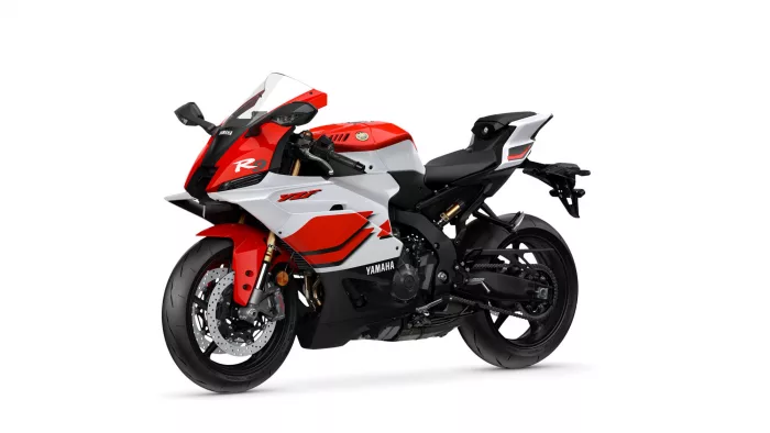 Red and white Yamaha sport motorcycle shown from a front-side angle, highlighting aerodynamic fairing and dual disc brakes on the front wheel