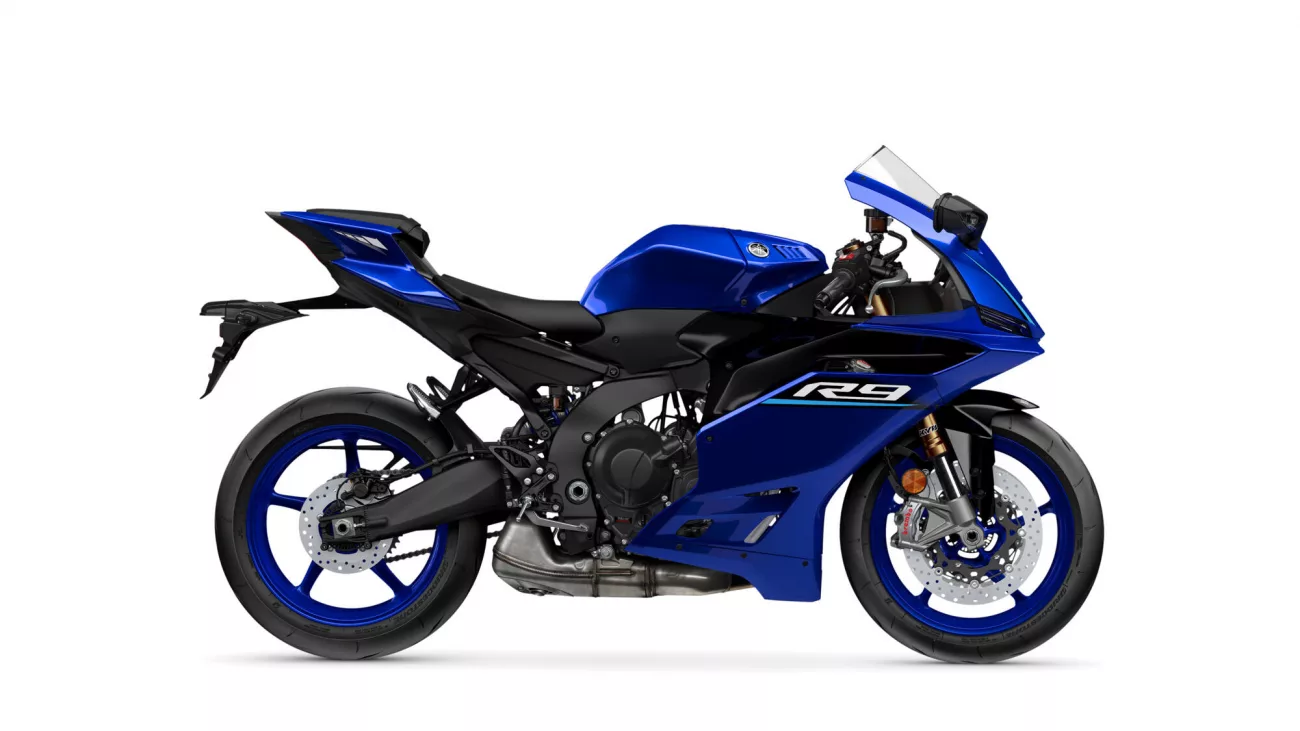 Blue sport motorcycle shown in side profile, with 'R9' branding on the fairing (rear wheel toward left).