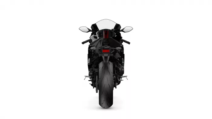 Rear view of a black sport motorcycle with a red tail light against a white background.