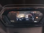 Digital car instrument cluster showing speed at 0 km/h, tachometer up to 12, fuel gauge on left, engine temp on right, odometer 65662 km, and external temp 29.0°C with a warning light on.