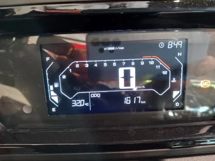 Digital car dashboard: speed shows 0 km/h, RPM gauge up to 11, odometer reads 1617 km, fuel left, engine temperature right, time 8:49.